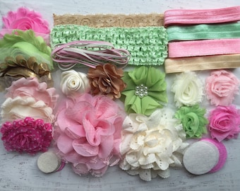 May include: An assortment of handmade floral embellishments and headbands in various colors. The collection includes pink, green, white, and gold fabric flowers, lace, and elastic headbands. Some flowers have pearl accents.