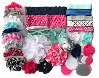 May include: A collection of colorful hair accessories, including headbands, fabric flowers, and felt circles. The headbands feature various designs, such as lace, polka dots, and solid colors. The flowers come in shades of pink, white, and blue.