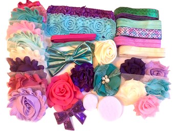 May include: A collection of colorful fabric flowers, bows, and ribbons in shades of purple, pink, teal, and white. These items are perfect for making hair accessories or embellishing crafts.