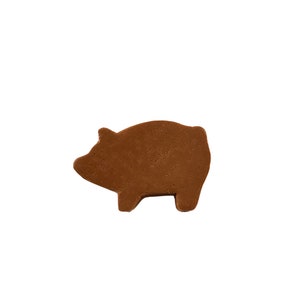 May include: A brown chocolate pig-shaped sweet.
