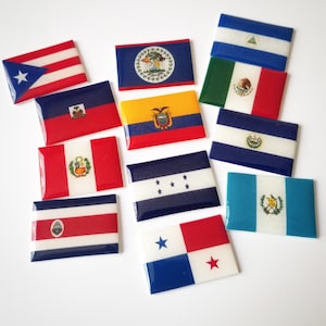 May include: A collection of 11 small, rectangular flags representing different countries. The flags are printed on a white background and have a glossy finish. The flags include: Puerto Rico, Haiti, Ecuador, Honduras, Panama, Belize, Nicaragua, Costa Rica, Guatemala, El Salvador, and Mexico.