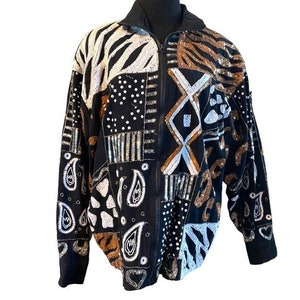 May include: A black sequined jacket with a zipper closure. The jacket features a patchwork design with various animal prints and geometric patterns in silver, gold, and brown.