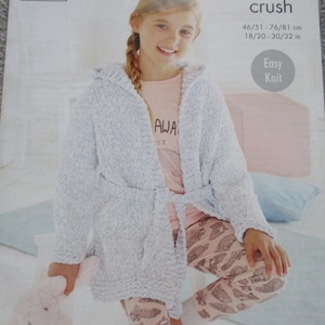 May include: A light blue knitted robe with a hood and a tie belt. The robe is easy to knit and is available in sizes 46/51 cm to 76/81 cm. The pattern is called "Yummy Crush" and is from King Cole.