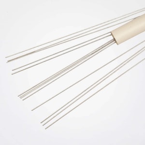 May include: A set of thin, silver-coloured metal rods bundled together with a white plastic handle. The rods are arranged in a fan shape.