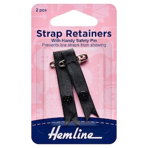 May include: Pack of two black strap retainers with safety pins. The packaging is pink and says "Strap Retainers with Handy Safety Pin Prevents bra straps from showing" and "Hemline".