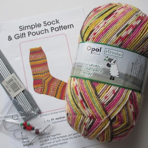 May include: A skein of multicoloured yarn in shades of yellow, pink, and brown with a label reading Opal Viridian, a printed Simple Sock & Gift Pouch Pattern, a set of metal double-pointed knitting needles, and a small bag of stitch markers.