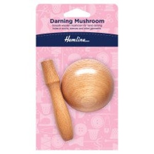 May include: A wooden darning mushroom with a round base and a handle. The mushroom is used for mending holes in fabric.