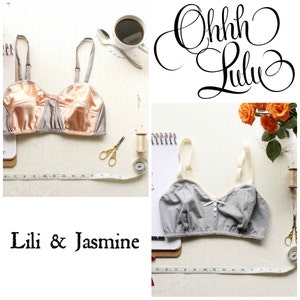 May include: Two gray and peach colored bras with white straps and bows. The bras are on a white surface with measuring tape and sewing supplies. The text "Lili & Jasmine" is at the bottom of the image.