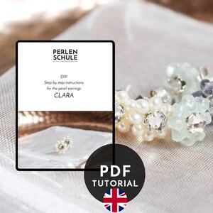 May include: A PDF tutorial titled PERLEN SCHULE DIY Step by step instructions for the pearl earrings CLARA, featuring three pairs of flower-shaped stud earrings in white, light green, and dark blue, each with a central clear crystal stone.