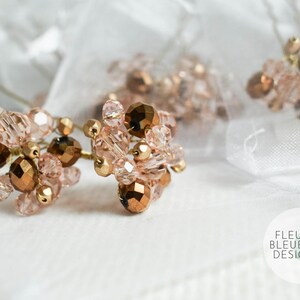 May include: Close-up of several hair pins with clusters of rose gold and bronze beads. The pins are arranged on a white surface with a sheer, white fabric in the background. The Fleur Bleue Design logo is visible.