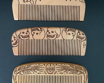 Wooden  comb featuring one of three designs. Two by the great Mr. Heggie and one by Lozzy Bones.