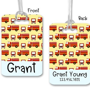 May include: Red fire truck luggage tag with a yellow background. The front of the tag says "Grant" and the back says "Grant Young 123.456.7891".