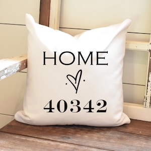 May include: White throw pillow with black text that reads "HOME" with a heart symbol and the number "40342".