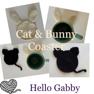 May include: Crocheted cat and bunny coasters in cream and black. The bunny coaster has long ears, and the cat coaster has a tail. The coasters are shown with a teal mug. Text on the image reads "Cat & Bunny Coaster" and "Hello Gabby".