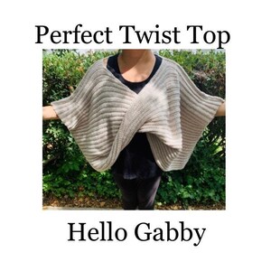 Op de afbeelding: Een lichtbeige Perfect Twist Top met een geribbelde textuur. De top is over de schouders gedrapeerd. De tekst "Perfect Twist Top" en "Hello Gabby" wordt in zwarte letters weergegeven.