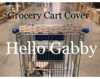 May include: A blue shopping trolley with a rainbow patterned fabric cover on the handle. The text "Grocery Cart Cover" and "Hello Gabby" is visible in the image.