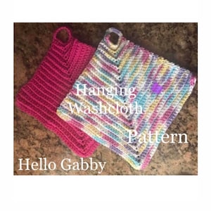 Könnte beinhalten: Zwei gehäkelte Hängetücher, eines rosa und eines mehrfarbig, mit einer Schlaufe zum Aufhängen. Der Text "Hanging Washcloth Pattern" ist auf dem Bild zu sehen.