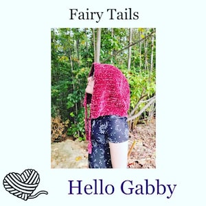 May include: A person wearing a burgundy hooded crocheted cowl with a black shirt with white stars and moons. The text "Fairy Tails" is at the top of the image and "Hello Gabby" is at the bottom of the image.