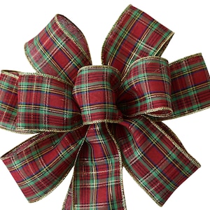 May include: A red, green and gold plaid bow with a gold wired edge.