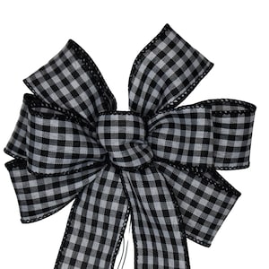 May include: A black and white gingham bow with a wired edge. The bow is tied in a classic shape with loops and tails.