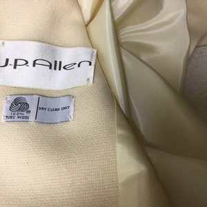 May include: A white wool coat with a J.P. Allen label and a tag that says "100% Pure Wool" and "Dry Clean Only."