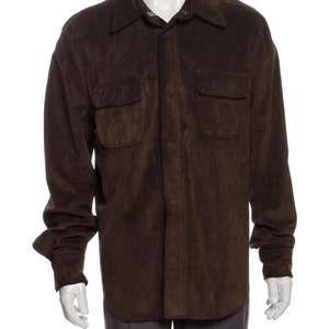 May include: A brown suede shirt with a button-down front and two flap pockets.