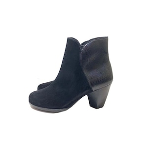 May include: Black suede ankle boots with a snakeskin-textured heel. The boots have a pointed toe and a block heel.