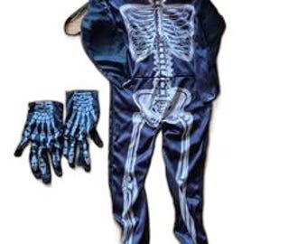 May include: A dark blue skeleton costume with a white skeletal design, including a hooded jumpsuit and matching gloves. The costume is designed to resemble a human skeleton. The gloves are also dark blue with a white skeletal design.