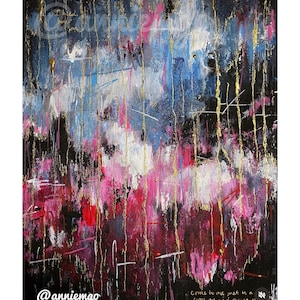 May include: Abstract painting with a dark background, featuring vertical gold lines and splashes of pink, white, blue, and red. The artist's name, @anniemgo, is visible in the lower left corner. The painting has a textured appearance.