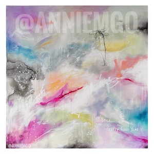 May include: An abstract painting featuring a blend of pink, blue, yellow, and gray washes with white splatters. A single line-drawn flower stands near the top, and the text "Still... PRETTY GOOD YEAR." is written in white in the lower right corner.