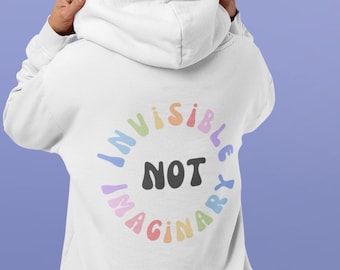 May include: White hoodie with a rainbow colored graphic on the back that says "Invisible Not Imaginary". The front of the hoodie has a smaller rainbow graphic that says "Invisible Illness Club".