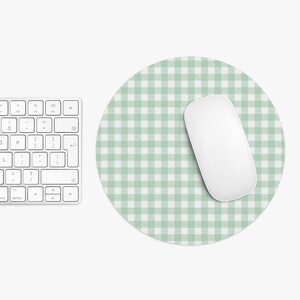 May include: A round green and white gingham mouse pad with a white wireless mouse on top.