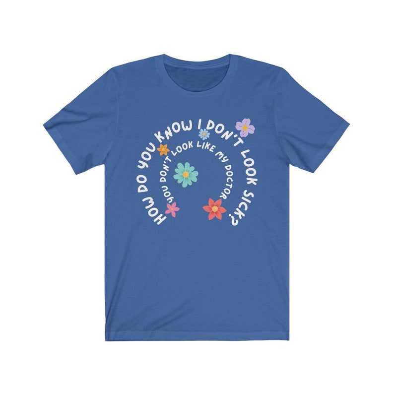 May include: A royal blue t-shirt with a white circle design featuring the text "How do you know I don't look like my doctor sick?" with colorful flower graphics around the text.