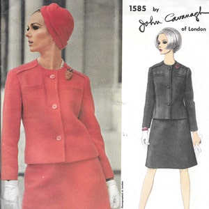 May include: Vogue Couturier Design pattern number 1585 by John Cavanagh of London. The pattern features a two-piece suit with a jacket and skirt. The model on the left is wearing a red suit with a white turban. The model on the right is wearing a black suit with a white blouse.