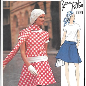 May include: A vintage sewing pattern from Vogue Paris Original, designed by Jean Patou. The pattern features a red and white gingham dress with a white belt and a white hat. The pattern also includes a blue skirt with a white belt. The pattern number is 2291.