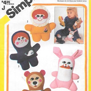 May include: Simplicity pattern 6013 featuring four plush toy designs: a bear with an ice cream bib, a doll, a figure in a dark blue suit with a whale, and a pink bunny. The image includes the Playskool logo and text.