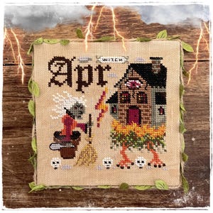 Puede incluir: Obra de arte de punto de cruz con un diseño de bruja para abril. La obra de arte incluye una casa con un ojo, una bruja con un caldero y la palabra "Apr" en letras grandes. La obra de arte está enmarcada con hilo y hojas verdes, con rayos en el fondo.