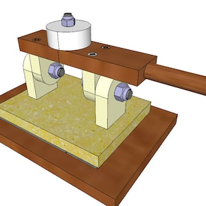 May include: A wooden tool with a handle and two rollers, used for pressing a yellow sponge-like material. The tool is mounted on a wooden base.