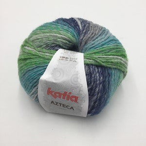 May include: A skein of Katia Azteca yarn in a multi-colored pattern of green, blue, and gray. The label reads "100 grs.-3 oz 1/2 180 mts.-197 yds. katia. AZTECA"