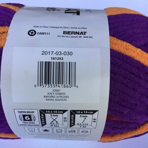 May include: A purple and orange yarn ball with the brand name "Bernat" and the product name "Juicy Stripes". The yarn is super bulky and has a 6 on the label. The label also includes the size and gauge information.