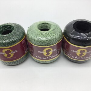 May include: Three spools of South Maid Crochet Thread, size 10. One spool is green, one is light green, and one is black.