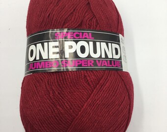 May include: A ball of deep red yarn with a label that reads "Special One Pound Jumbo Super Value".