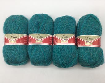 May include: Four skeins of teal blue yarn with a gold and red label that reads "Lotus Phrentex".