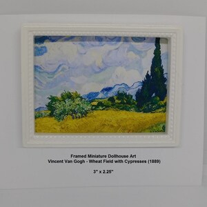 May include: A framed miniature dollhouse art print of Vincent Van Gogh's "Wheat Field with Cypresses" painting. The print is 3 inches by 2.25 inches and features a yellow field with a cypress tree in the background.