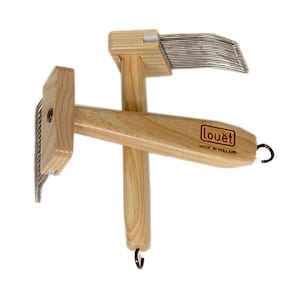 May include: Two wooden hand carders with metal teeth, used for preparing wool for spinning. The carders have wooden handles and a Louët logo on one of the handles.