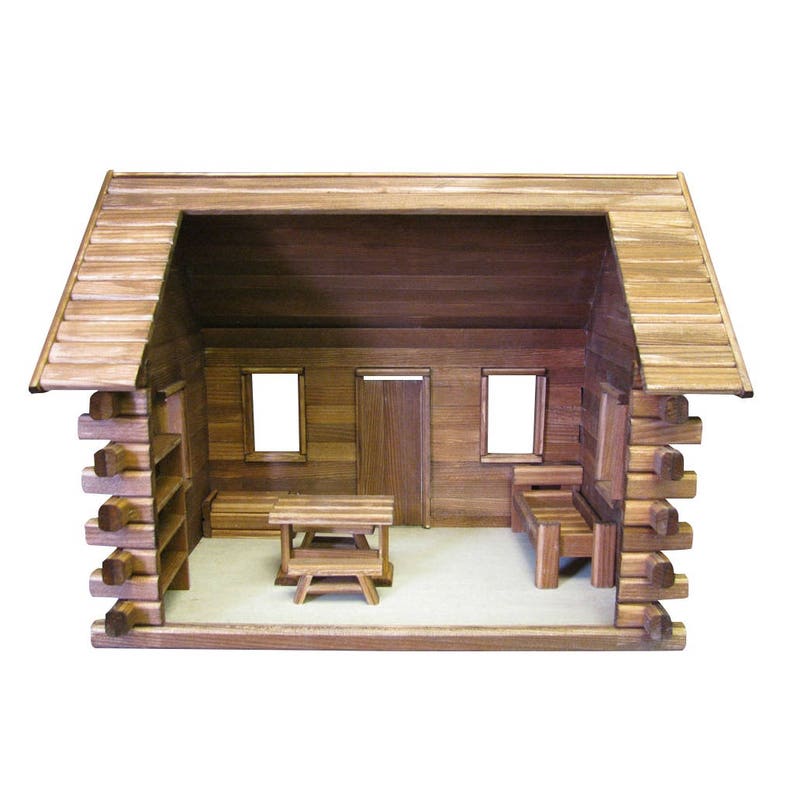 Finished 1-inch scale Crocketts Log Cabin Dollhouse Kit by Real Good Toys. Rear, inside view of log cabin dollhouse with one-room including log furniture. 13.5 inches tall x 18 wide. Kit sold unfinished.