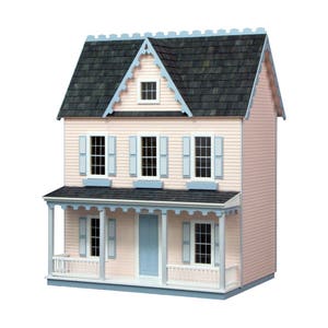 Finished 1-inch scale Vermont Farmhouse Jr. Dollhouse Kit by Real Good Toys. Front view, painted pink with blue trim. Milled MDF exterior, front porch, wooden roof shingles, shutters, window boxes. 29.4 in. tall x 24.25 wide. Kit sold unfinished.