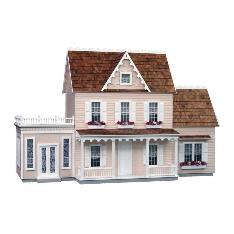 Finished 1-inch scale Vermont Farmhouse Jr. Dollhouse Kit by Real Good Toys. Conservatory and 2-story addition attached and sold separately. Front view, painted pink with white trim. Main house is 3-stories, 29.4 in H x 24.25 W. Kit sold unfinished.