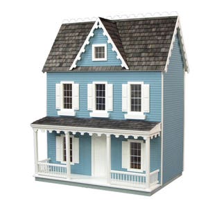 Finished 1-inch scale Vermont Farmhouse Jr. Dollhouse Kit by Real Good Toys. Front view, painted blue with white trim. Milled MDF exterior, front porch, wooden roof shingles, shutters, window boxes. 29.4 in. tall x 24.25 wide. Kit sold unfinished.