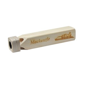 May include: A wooden whistle with a train design and the name "Mackenzie" engraved on it.